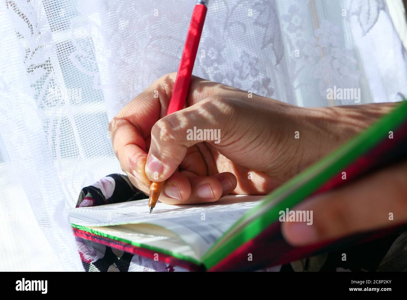 Close up of women hand writing on notepad Stock Photo - Alamy