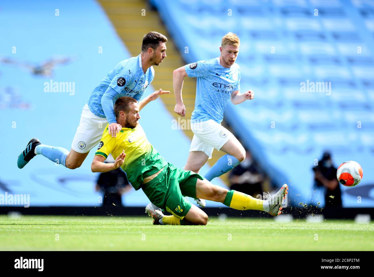 Manchester City's Aymeric Laporte and Norwich City's Marco Stiepermann (right) during the Premier League match at the Etihad Stadium, Manchester. Stock Photo