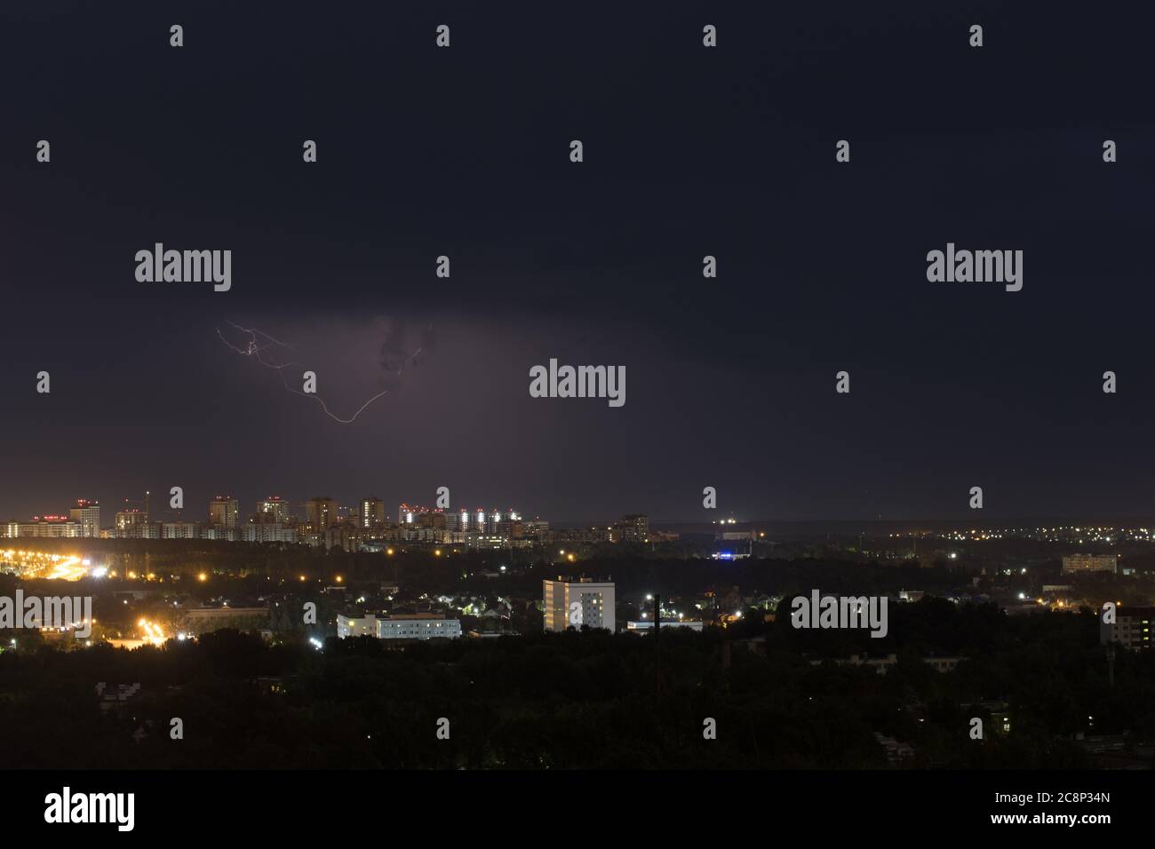 Lightning flashes in the night sky above the city. Background Stock ...