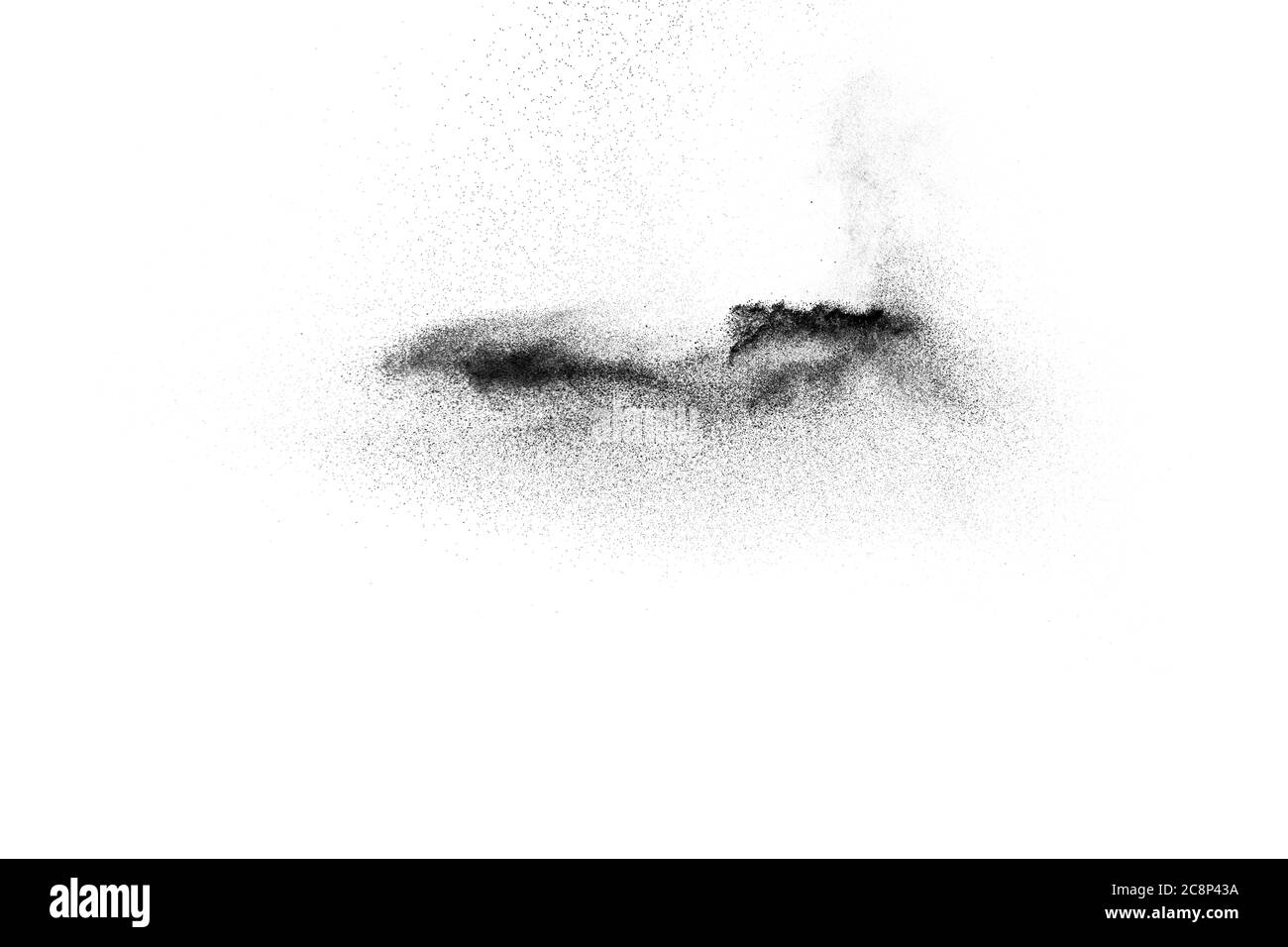 Black powder explosion on white background.Black dust particles splash. Stock Photo
