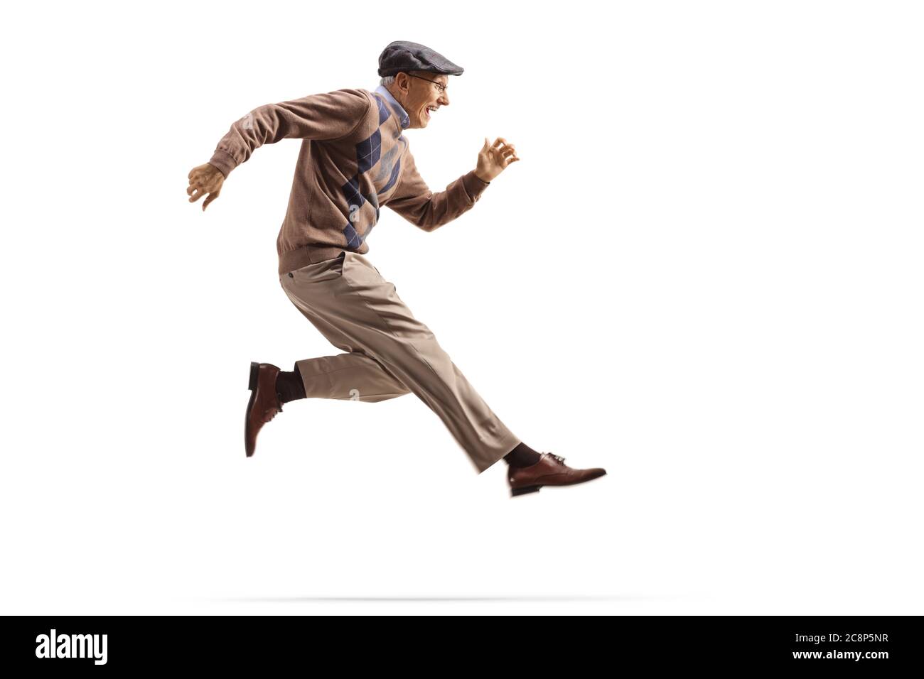 Excited elderly man jumping and kicking isolated on white background Stock Photo