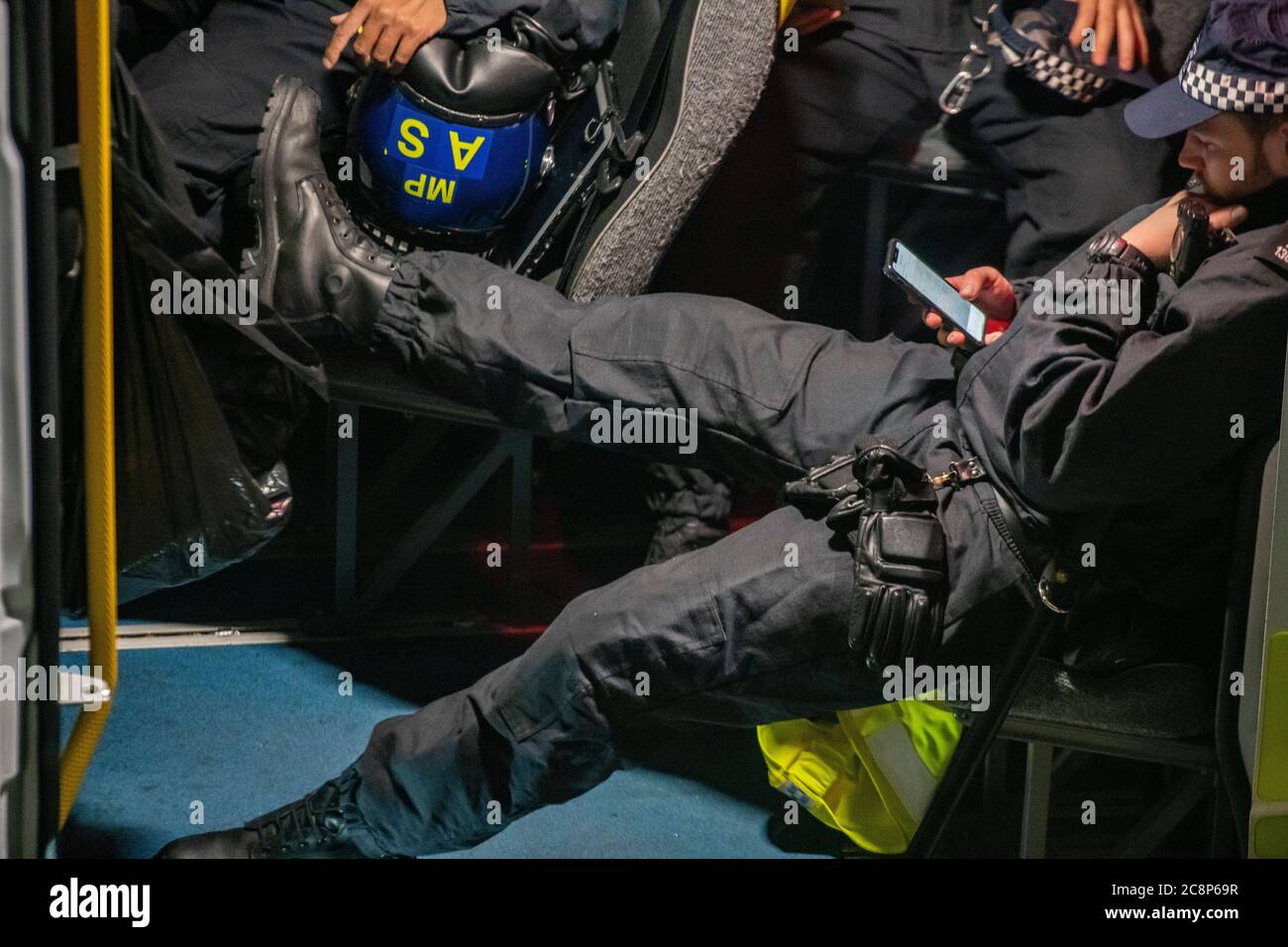 Policemen await instructions for action in a police van during lockdown in July 2020 Stock Photo