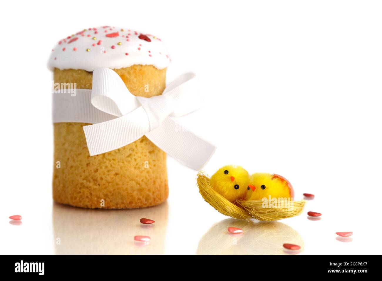 Traditional Easter cake with two yellow chicks and white ribbon isolated on white background Stock Photo