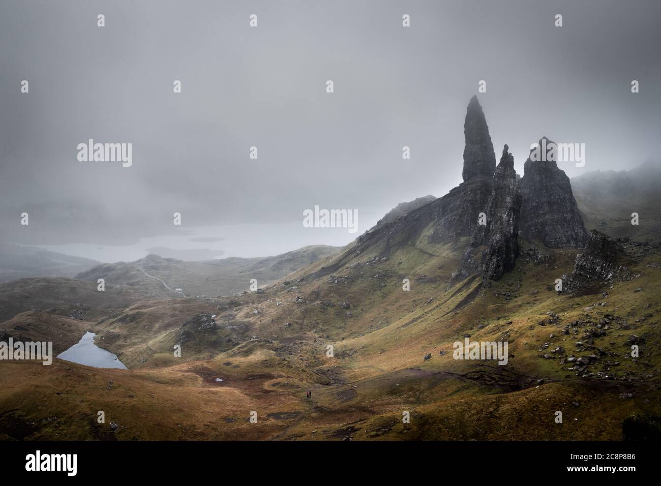 Der Old Man of Stor in Schottland umgeben von einer nebligen, mystischen Landschaft mit Blick auf einen See Stock Photo