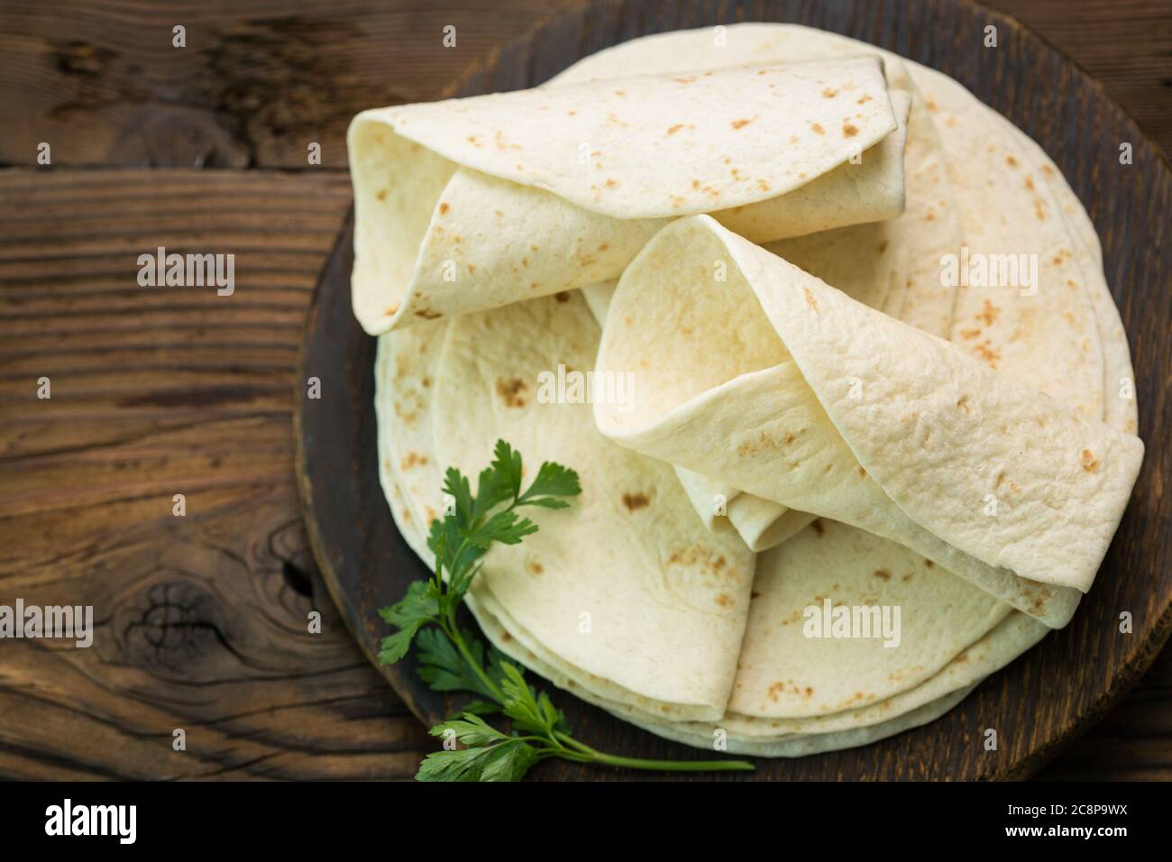 Whole wheat flour tortilla on the wooden table background Stock Photo