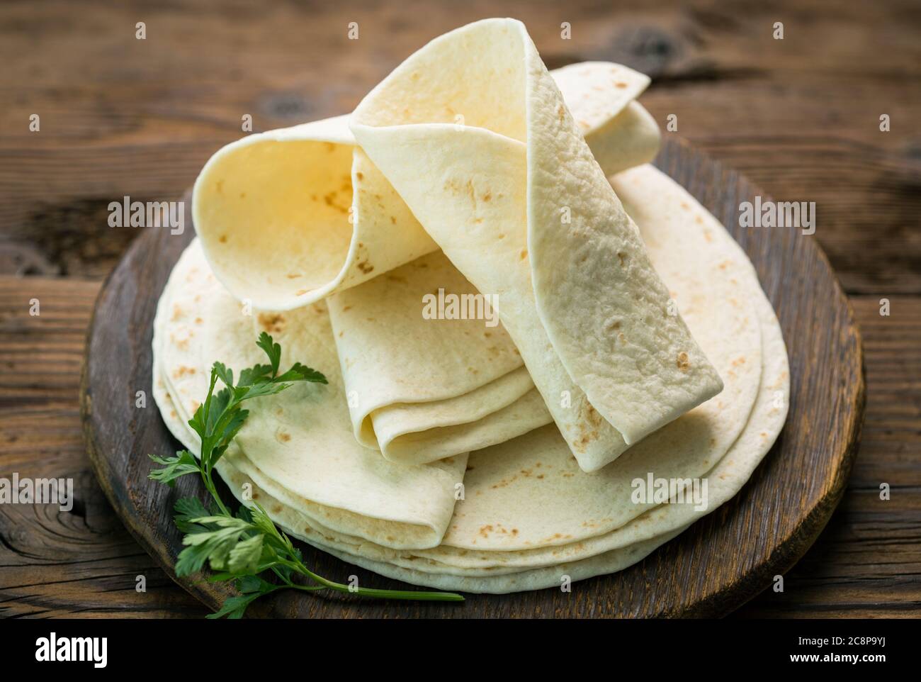 Whole wheat flour tortilla on the wooden table background Stock Photo