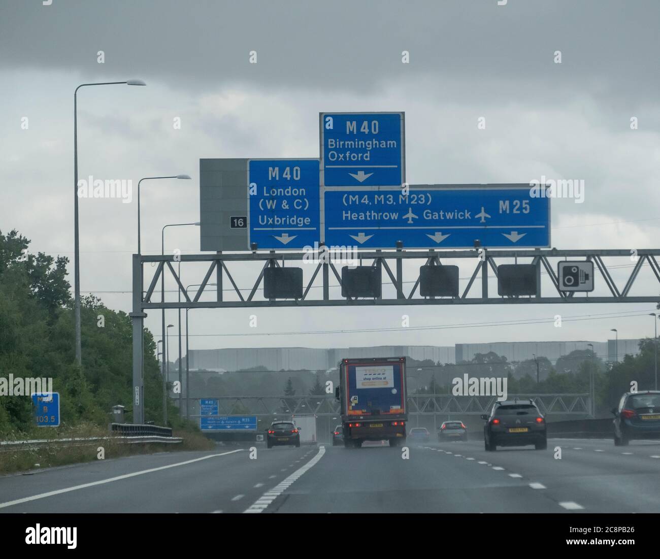 London, UK. 26 July 2020. Mixed spells of heavy rain and sunny spells for drivers on the M25 London Orbital motorway on a busy Sunday afternoon. Credit: Malcolm Park/Alamy Live News. Stock Photo