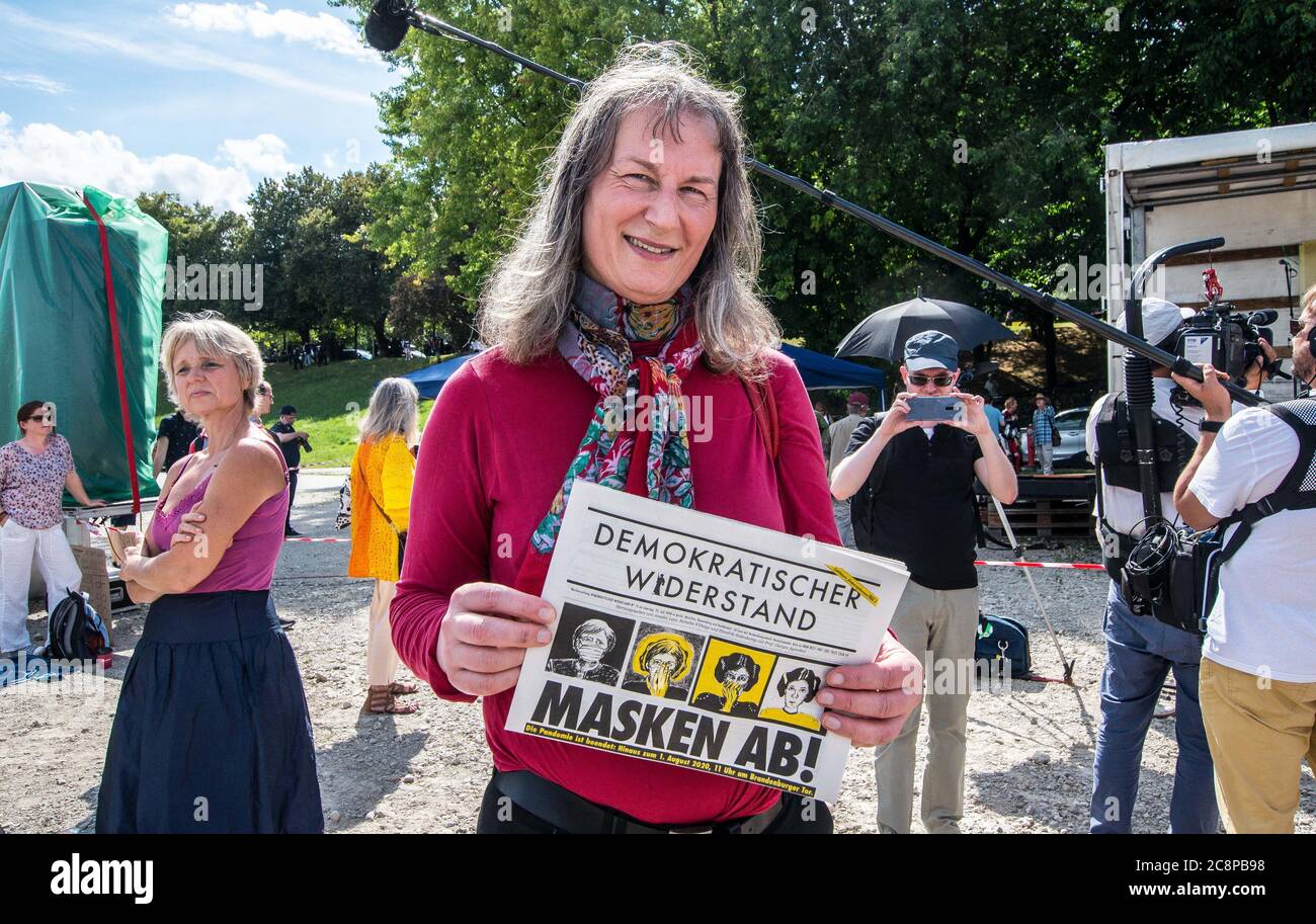 Munich, Bavaria, Germany. 25th July, 2020. MISHA ROSALIE BOSSNECKER poses with a copy of the far-right and conspiratorial Demokratischer Widerstand. Under a similar organization as the so-called 'Hygienedemos'', a mixture of over 300 poorly-spaced extreme-right, right-populist, and Querfront figures held a 'To Freedom'' concert at Munich's Theresienwiese. A group demonstrated against the Corona Rebels, conspiracy theories, and anti-Semitism. Critics allege that the groups presented a music festival and evening dance festival in order to camouflage another hygienedemo with the group so Stock Photo