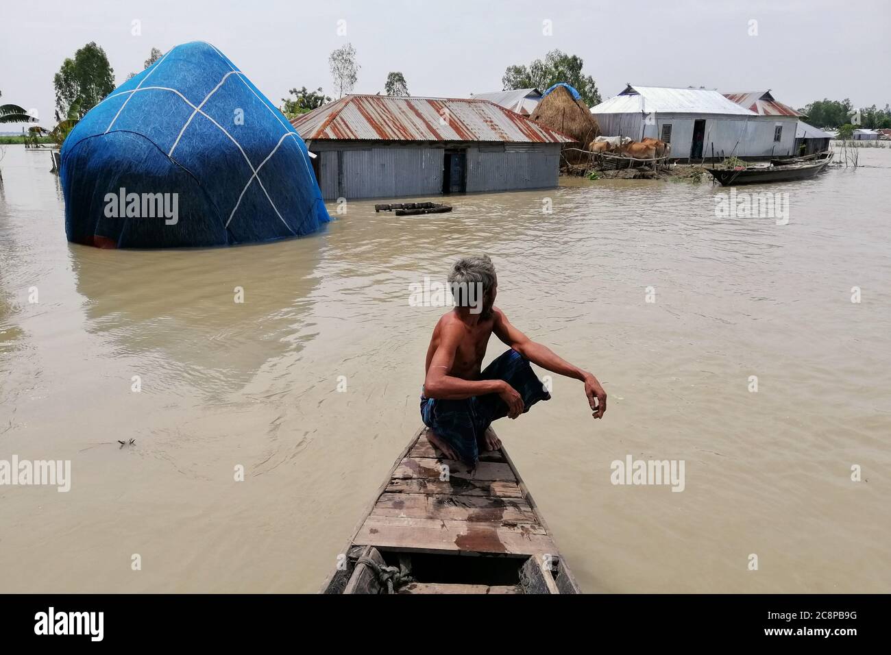 People living on boats after flood water  submerged their home Stock Photo