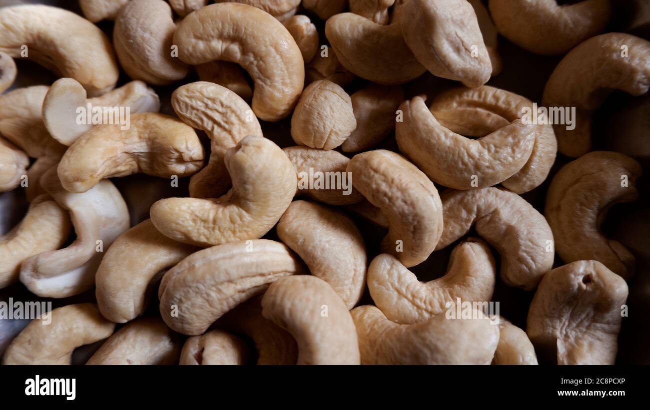 a close up shot of cashew nuts group healthy dry fruit nuts in full frame Stock Photo