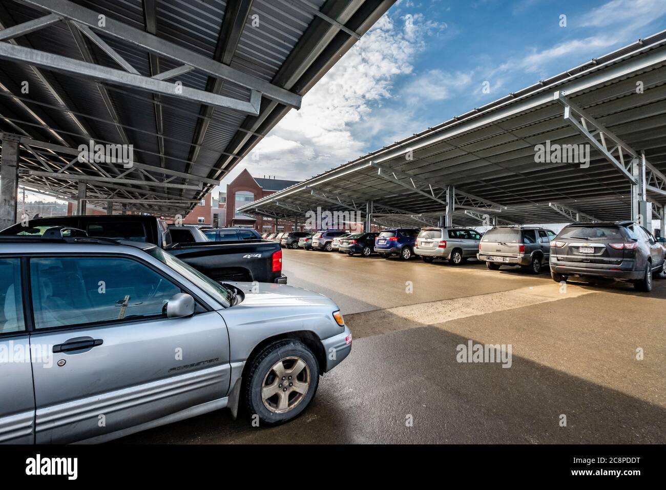 Solar panels installed at Heywood Hospital in Gardner, MA provide electricity for the hospital and cover for the cars in the parking lot. Stock Photo