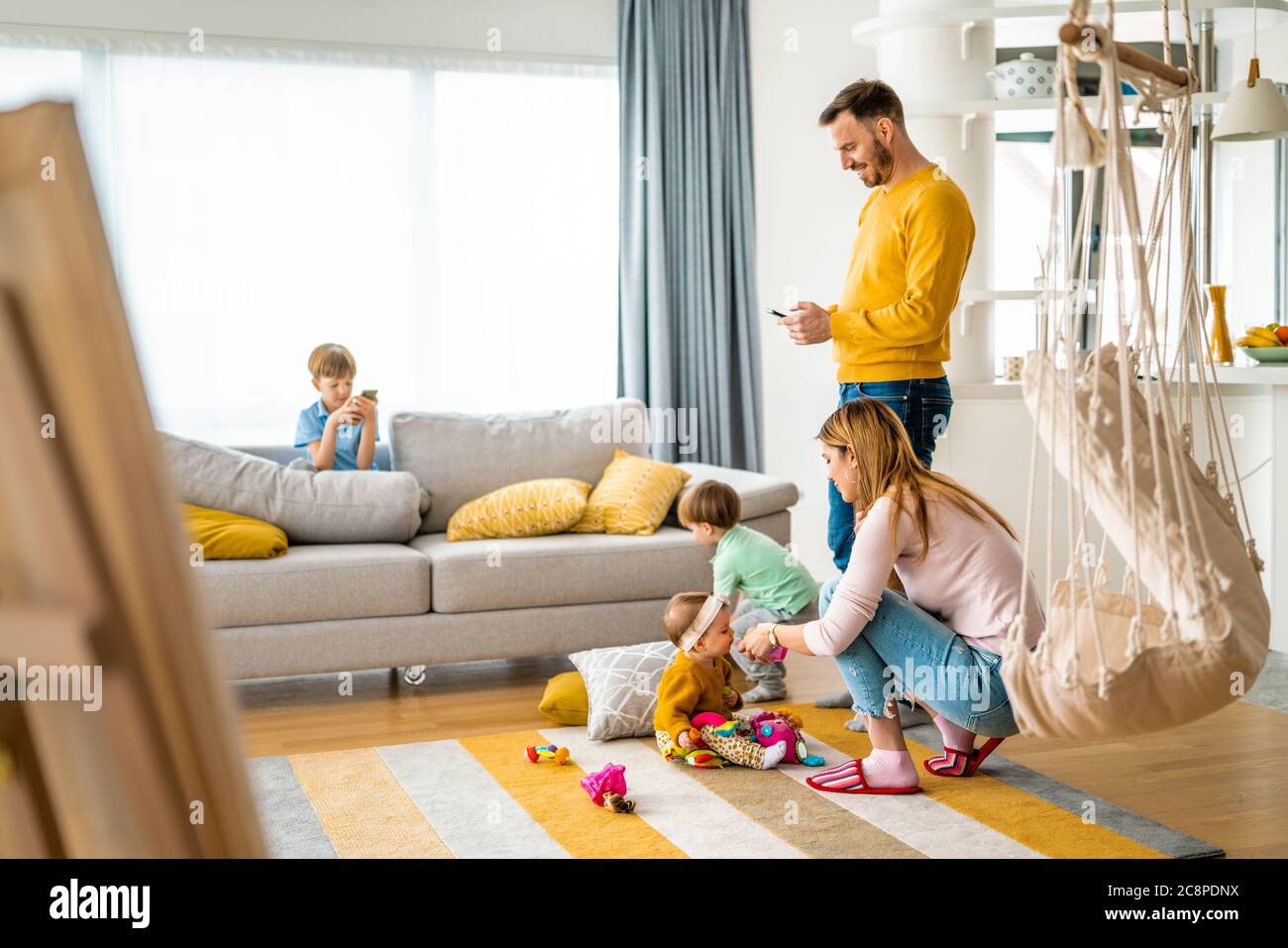 Happy young family spending time together at home Stock Photo