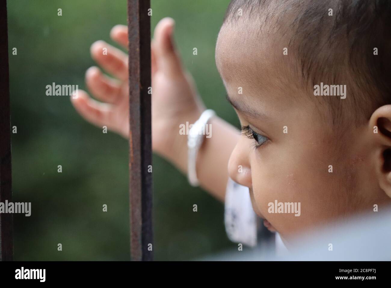 Cute Indian Baby looking from window Stock Photo
