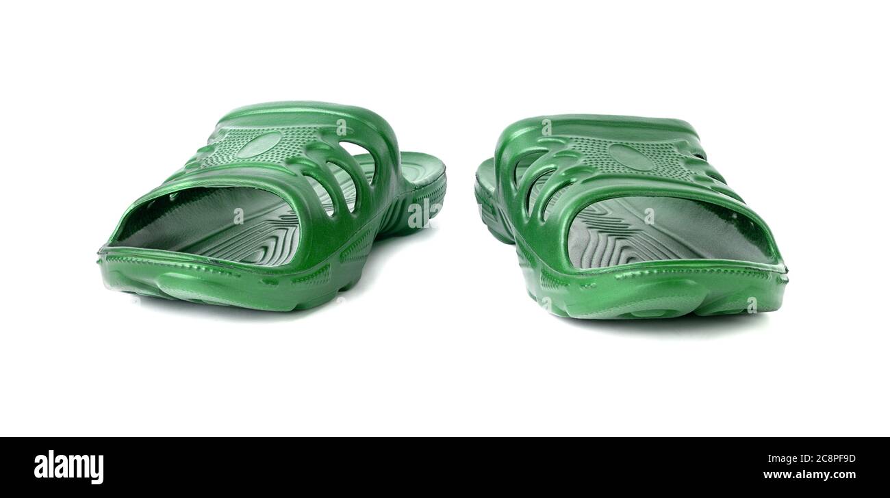 pair of cheap durable green rubber slippers isolated on white background. Stock Photo