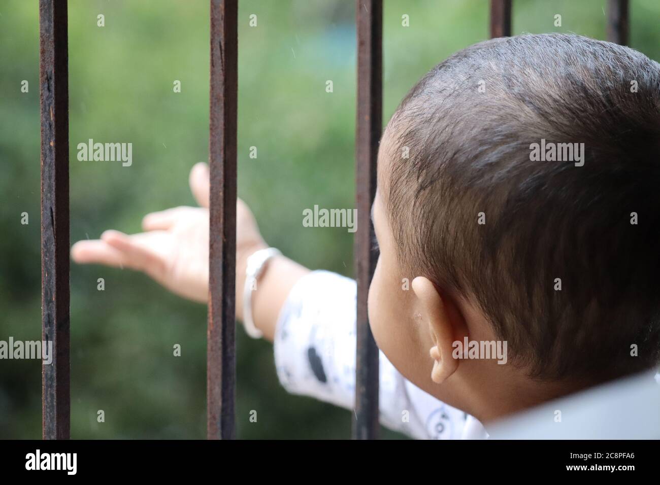 Cute baby at window Stock Photo