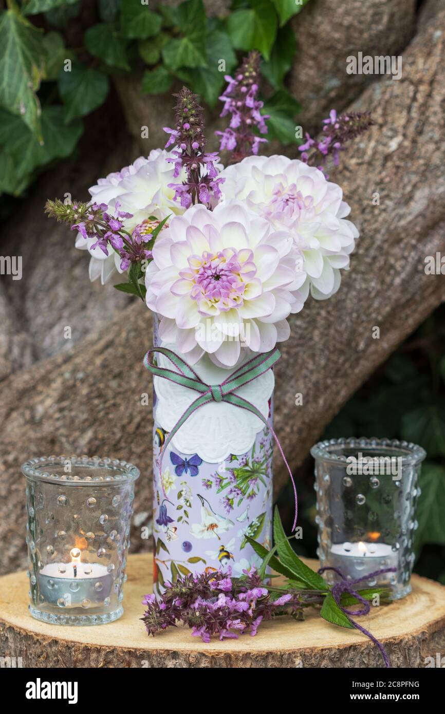bouquet of white and purple dahlias and sage and table lanterns Stock Photo