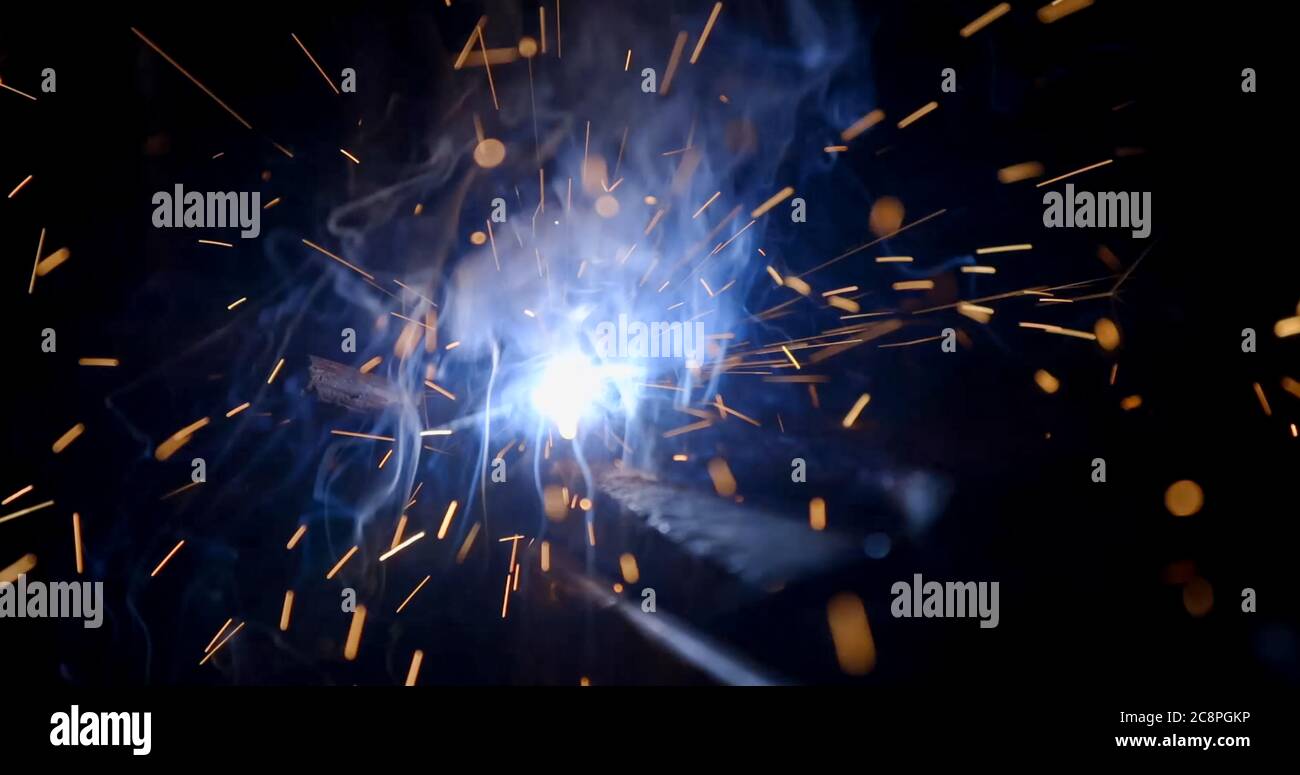 welder working with electrode at semiautomatic arc welding in
