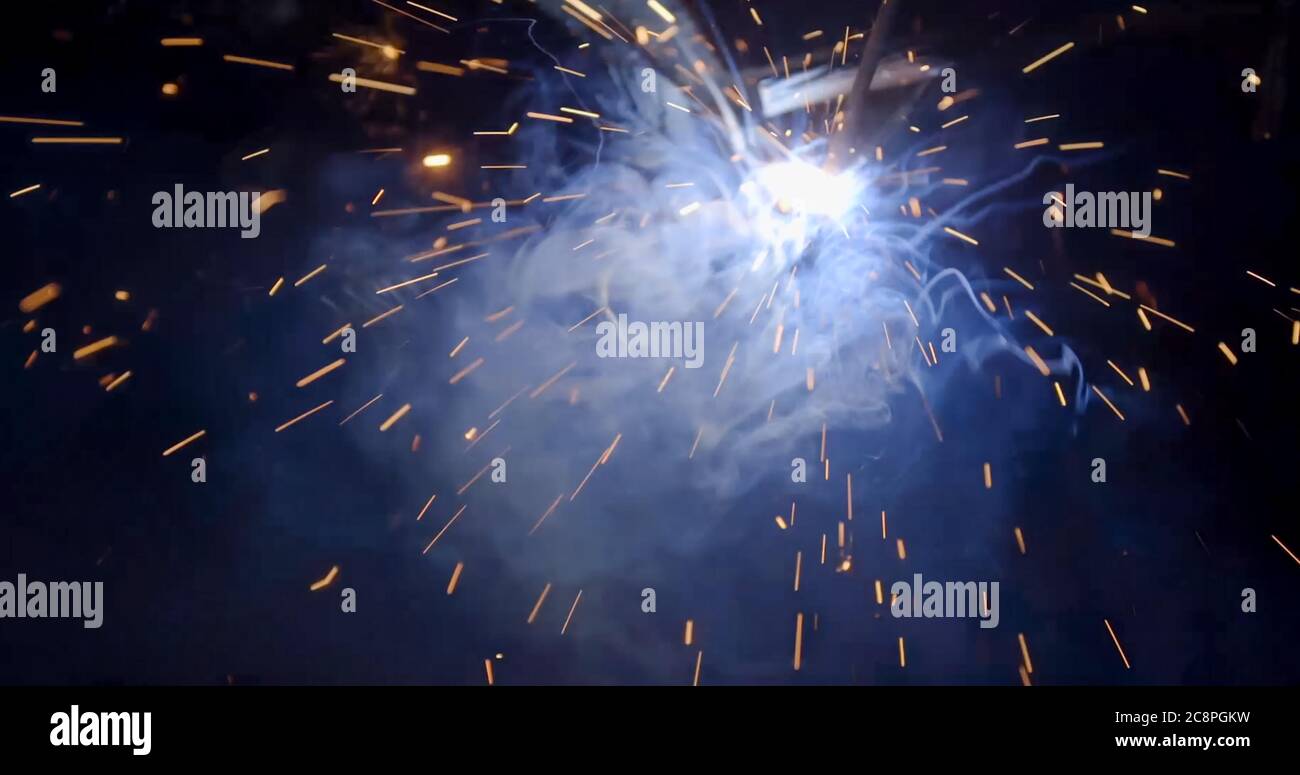 welder working with electrode at semiautomatic arc welding in