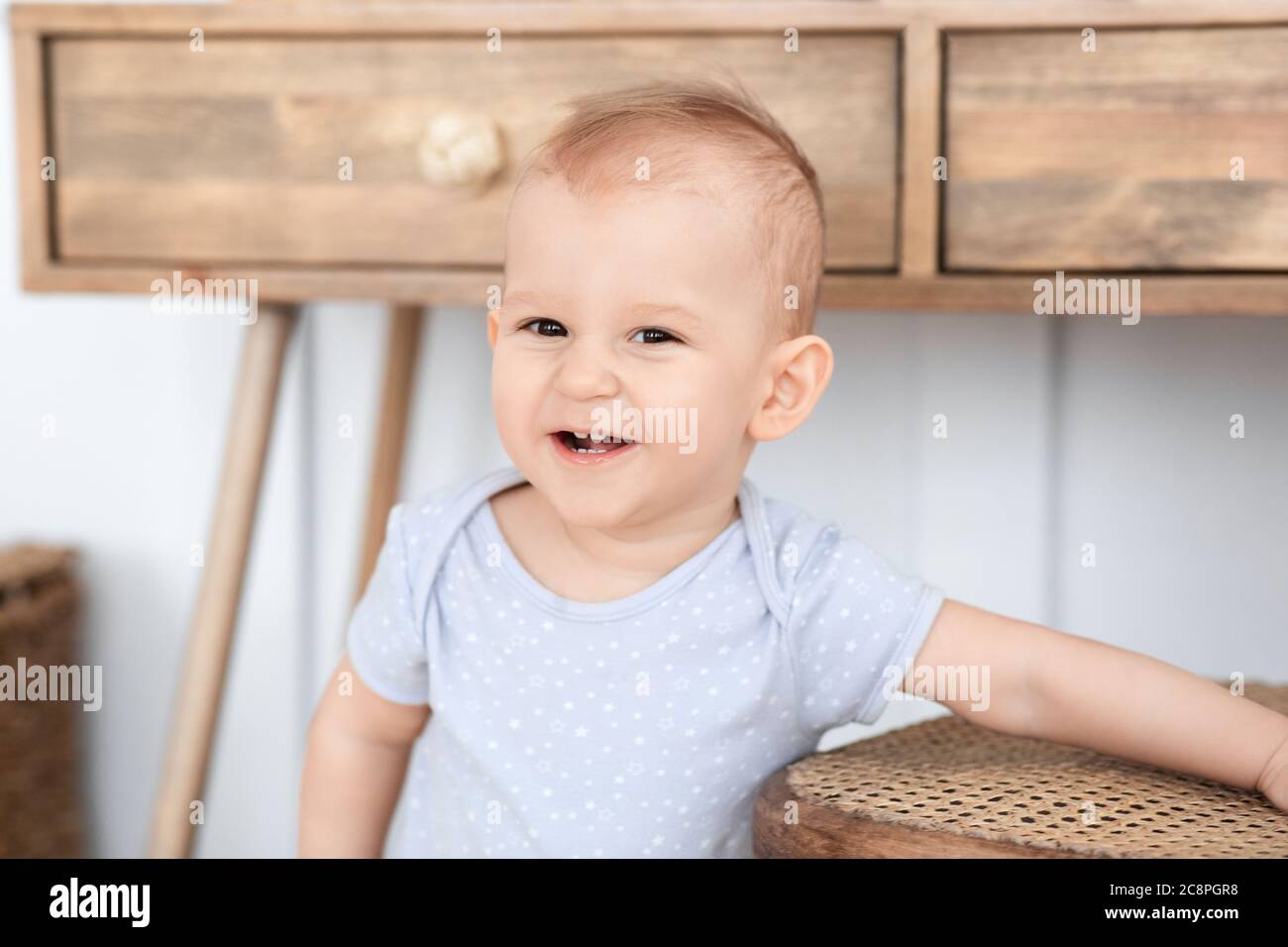 Baby Portrait. Adorable Smiling Toddler Boy Posing At Home, Looking At Camera Stock Photo