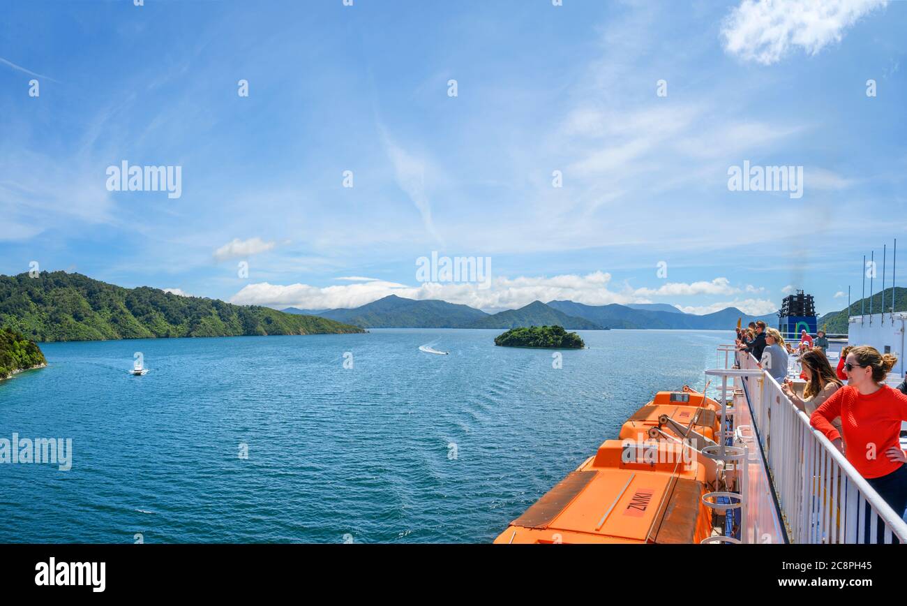 Passengers viewing the Marlborough Sounds from the deck of the Wellington to Picton ferry, South Island, New Zealand Stock Photo