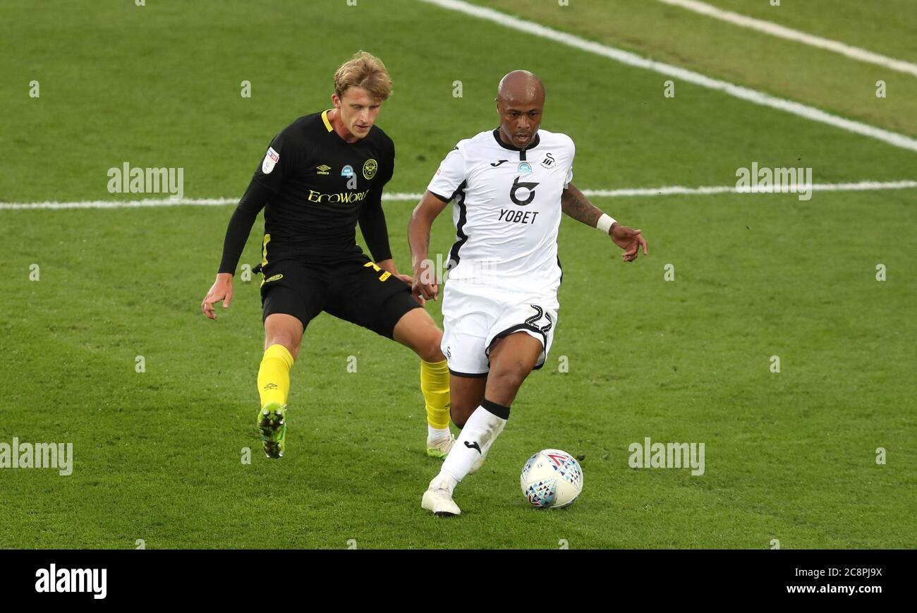 Brentford's Mads Roerslev Rasmussen (left) and Swansea City's Andre Ayew battle for the ball during the the Sky Bet Championship play-off first leg match at the Liberty Stadium, Swansea. Stock Photo