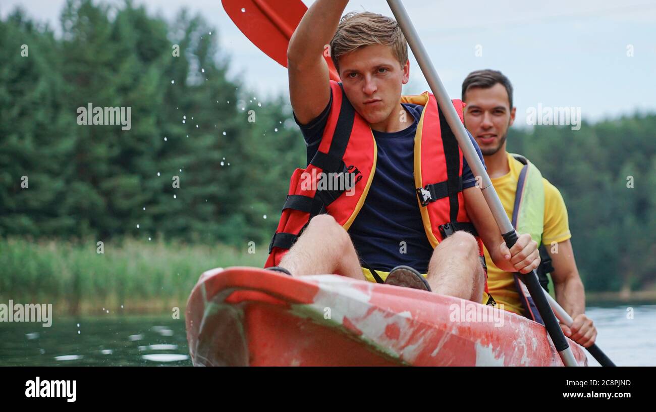 two guys in a red kayak on the river, in life jackets Stock Photo Alamy