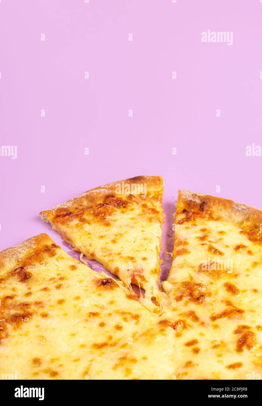 Sliced cheese pizza with mozzarella, closeup, isolated on a purple
