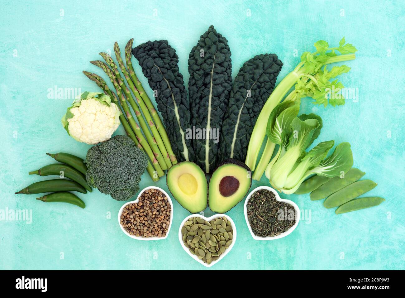 Healthy heart food with green vegetables, nuts, spice & herb selection