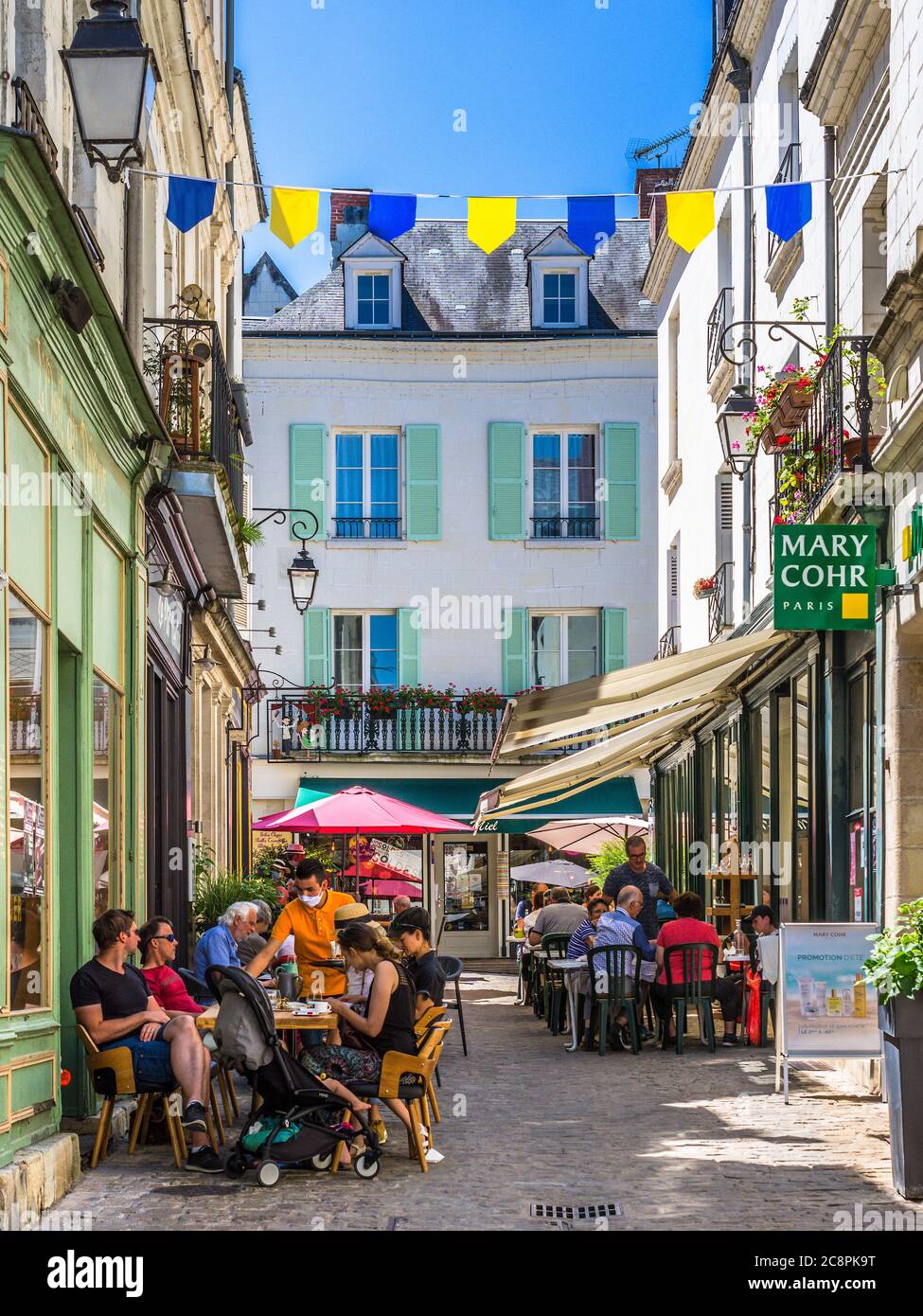 Outdoor restaurant tables with diners on the Grande Rue, Loches, Indre-et-Loire, France. Stock Photo