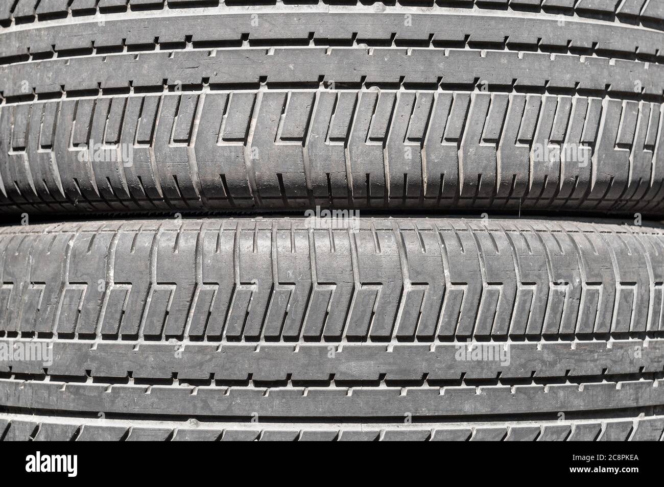 Stack of used tires in a car garage of installation service, abstract background. Stock Photo