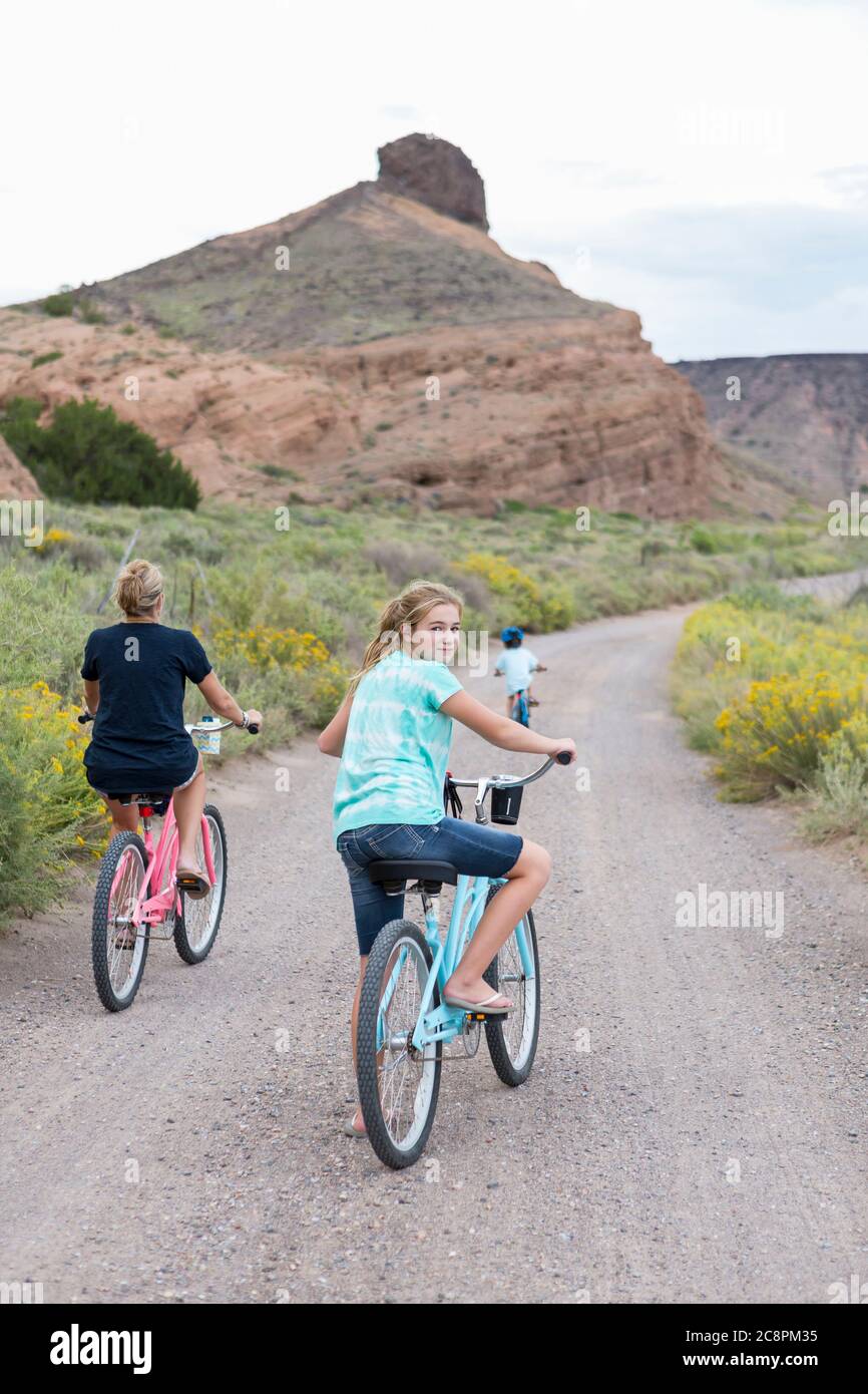 11 year old girl on bike looking back at camera Stock Photo