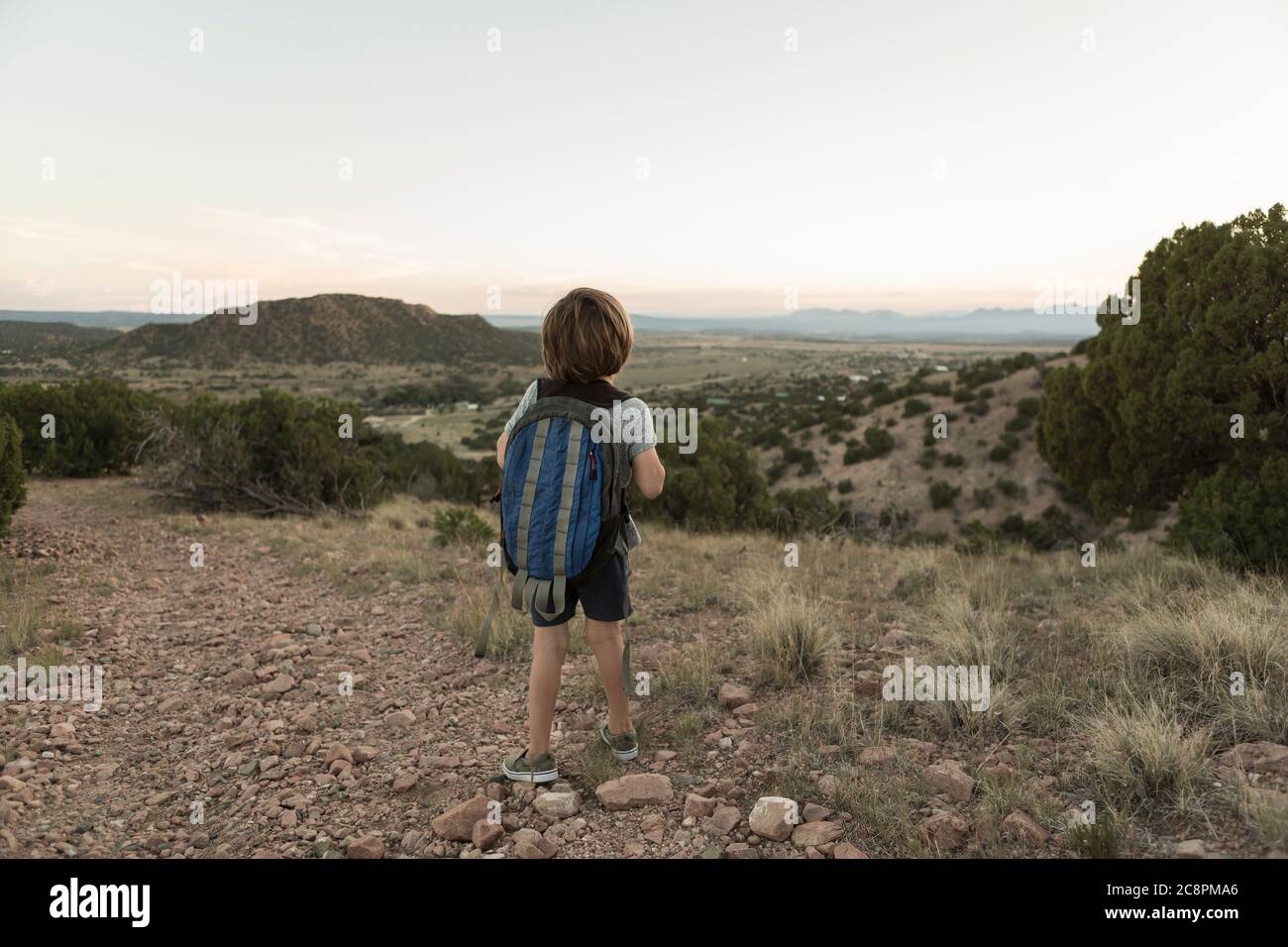 4 year old boy hiking at sunset, Lamy, NM Stock Photo