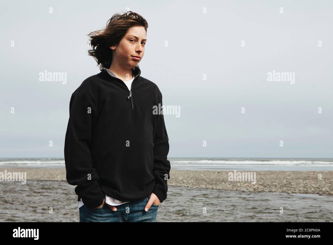 Portrait of moody teenage boy on beach Stock Photo - Alamy