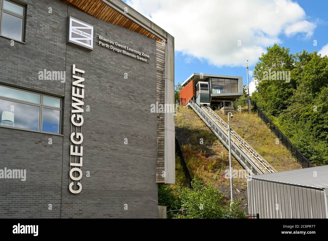 Ebbw Vale, Wales - July 2020: Building of the further education college 'Coleg Gwent'. In the background is the funicular railway which links the town. Stock Photo