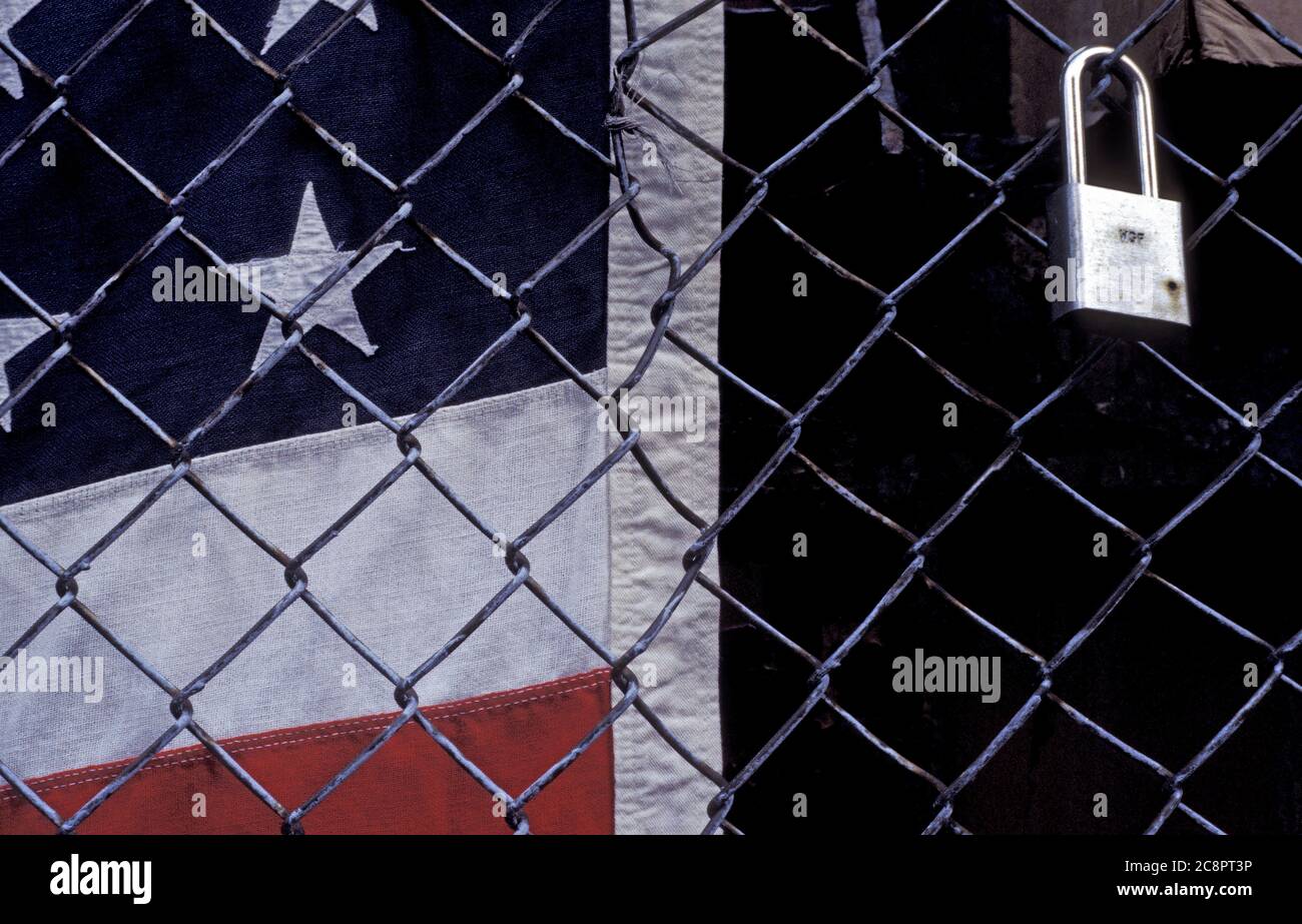 American flag behind fence with padlock. Stock Photo