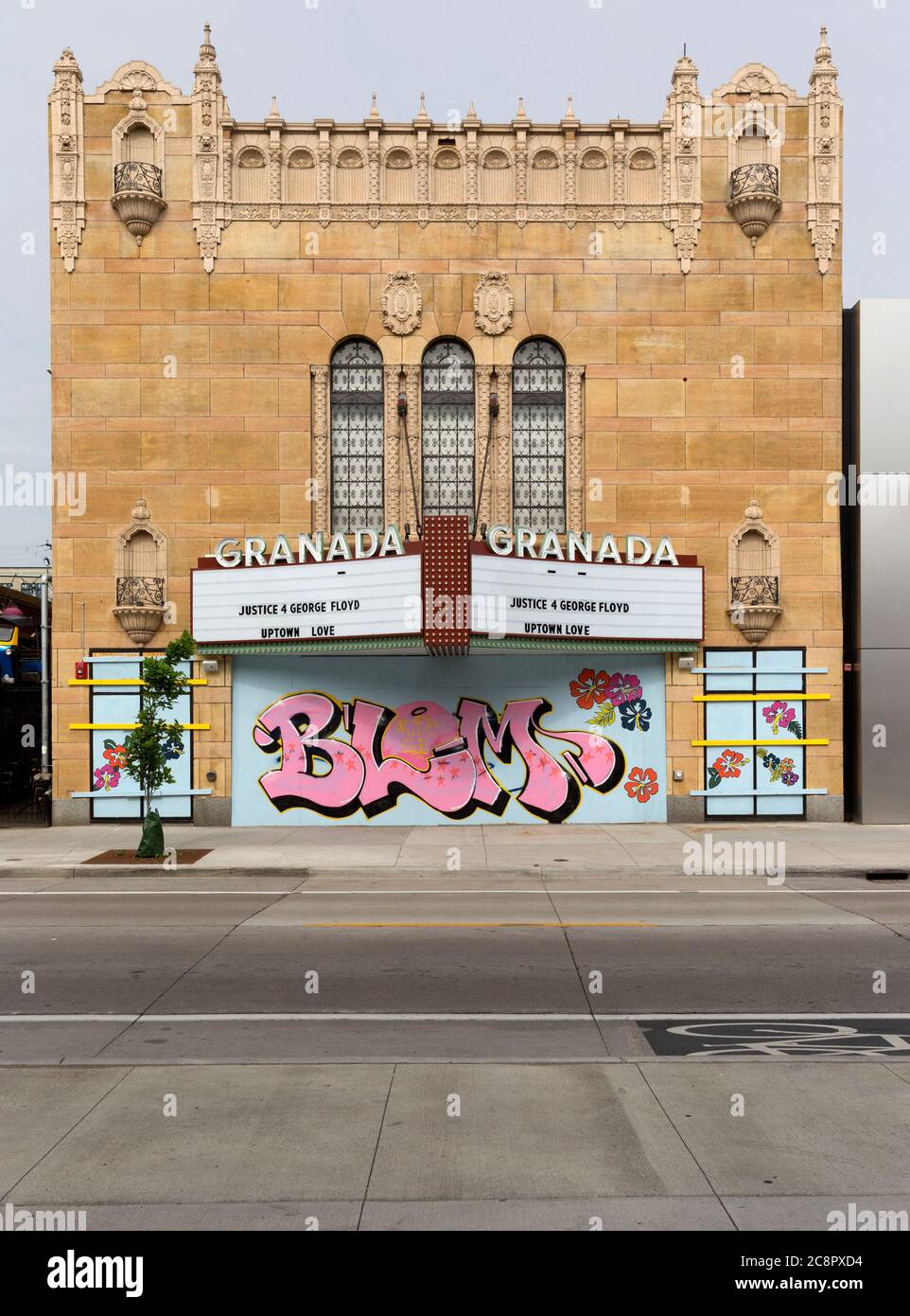 The boarded up exterior of the historic Uptown 1927 Granada Theater due to social protests in Minneapolis, Minnesota.  A BLM Black LIves Matter mural Stock Photo