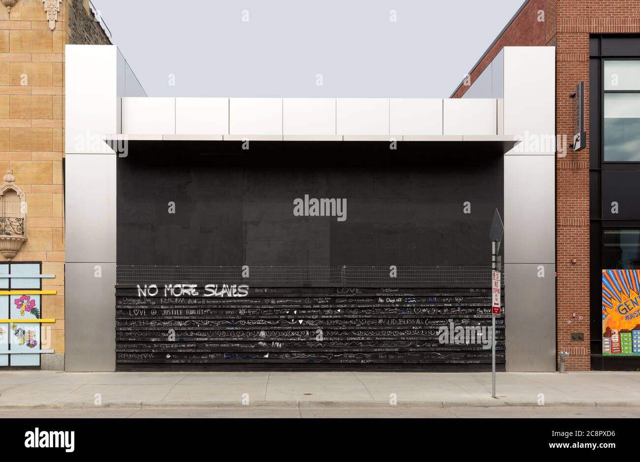 The boarded up exterior of the Apple Store  due to social protests in Uptown on Hennepin Avenue  in Minneapolis, Minnesota.  NO MORE SLAVES written in Stock Photo