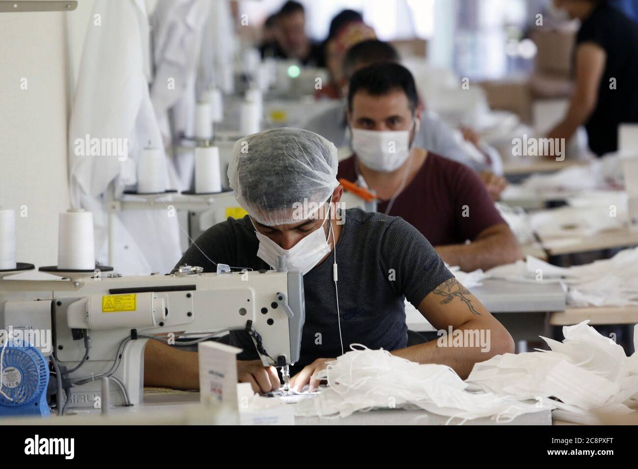 Ankara, Turkey. 26th July, 2020. Workers make face masks in Ankara, Turkey, on July 26, 2020. Turkey's COVID-19 cases increased by 927 on Sunday, while the total diagnosed cases climbed to 226,100, said Turkish Health Minister Fahrettin Koca. Credit: Mustafa Kaya/Xinhua/Alamy Live News Stock Photo