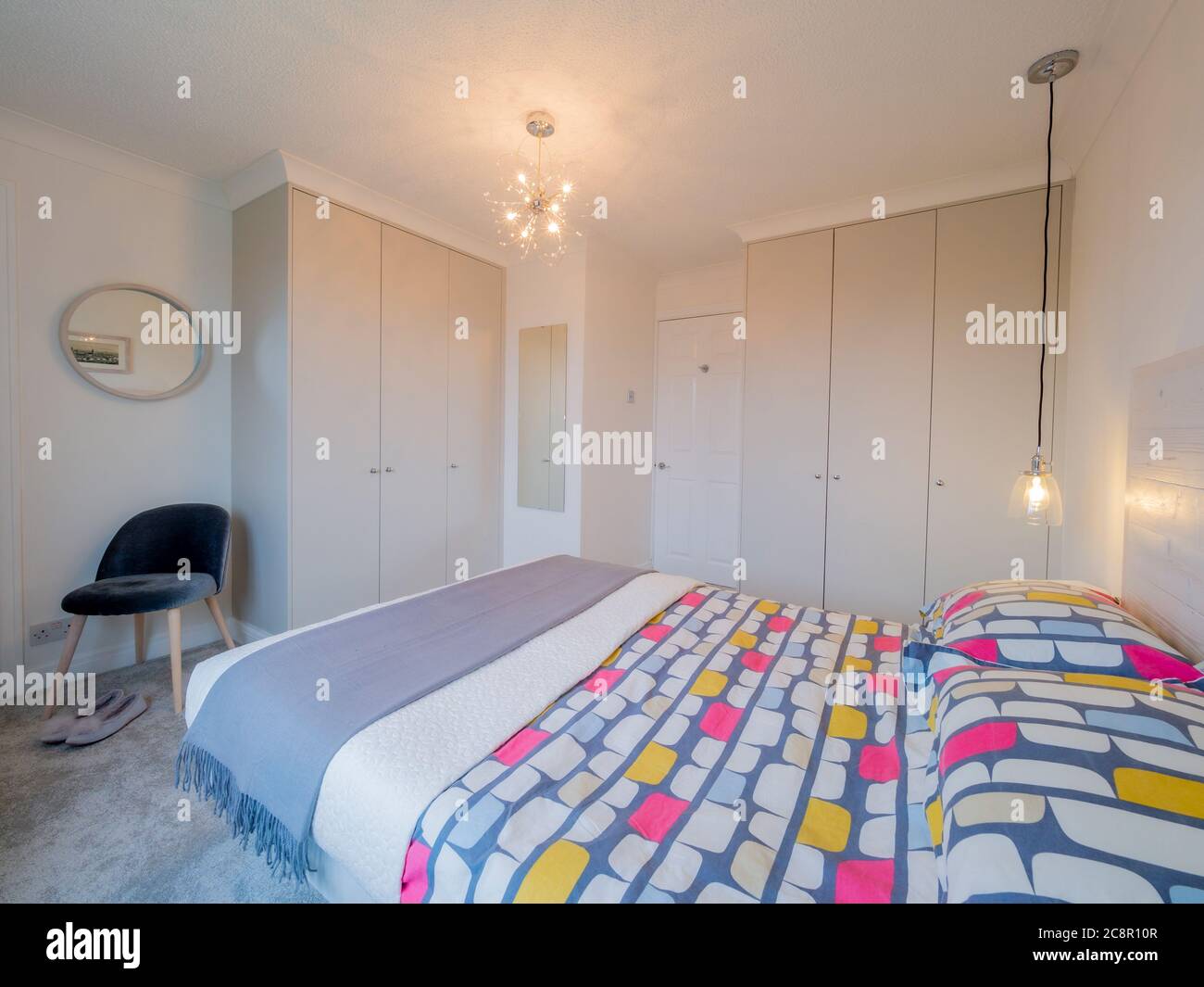 Bedroom interior with built in wardrobes Stock Photo