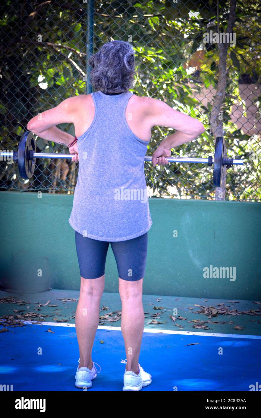 middle age woman training outdoors in quarantine Stock Photo
