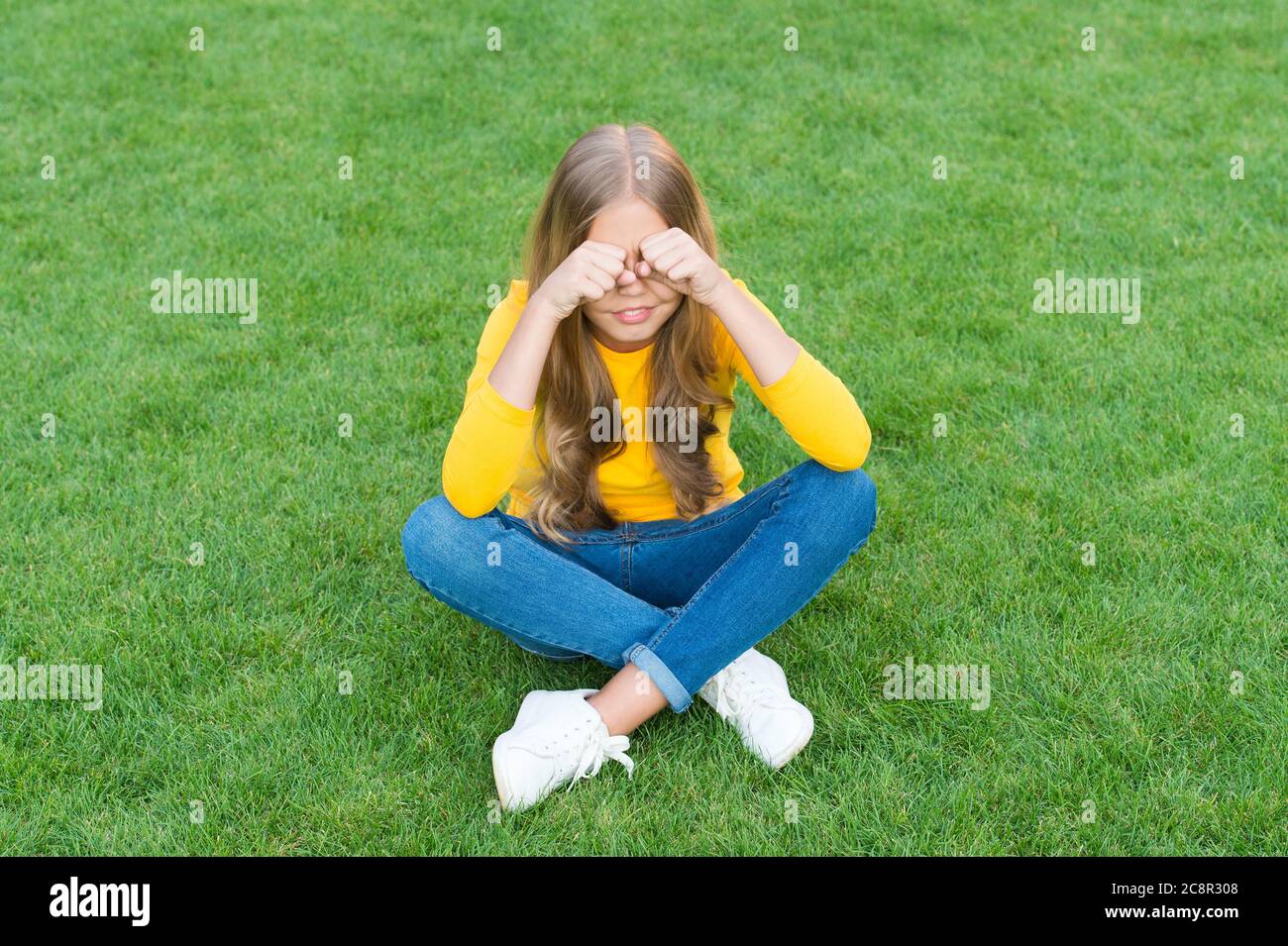 sad little girl sitting alone