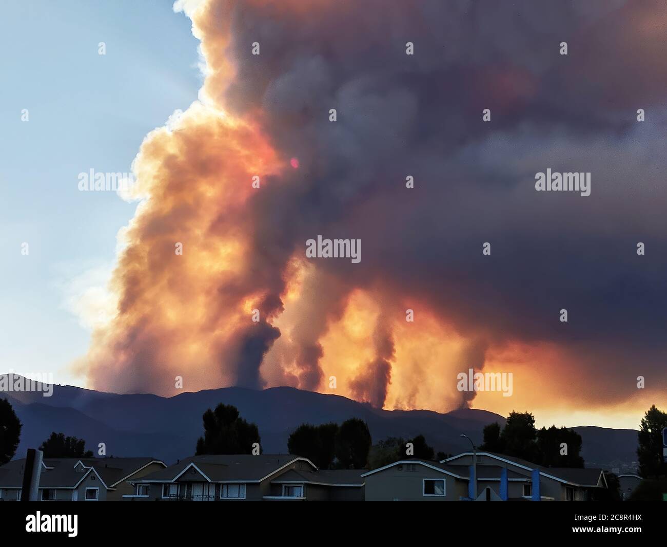 Huge columns of smoke rise from a brushfire Stock Photo