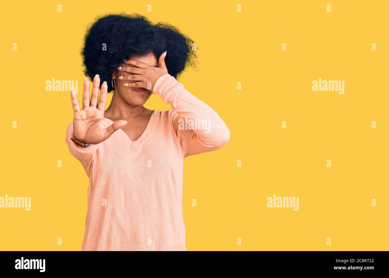 Young african american girl wearing casual clothes covering eyes with hands and doing stop gesture with sad and fear expression. embarrassed and negat Stock Photo