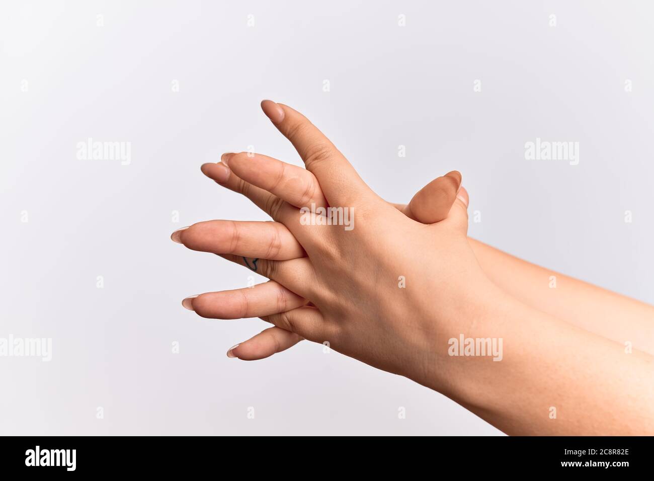 Hand of caucasian young woman stretching them with fingers intertwined