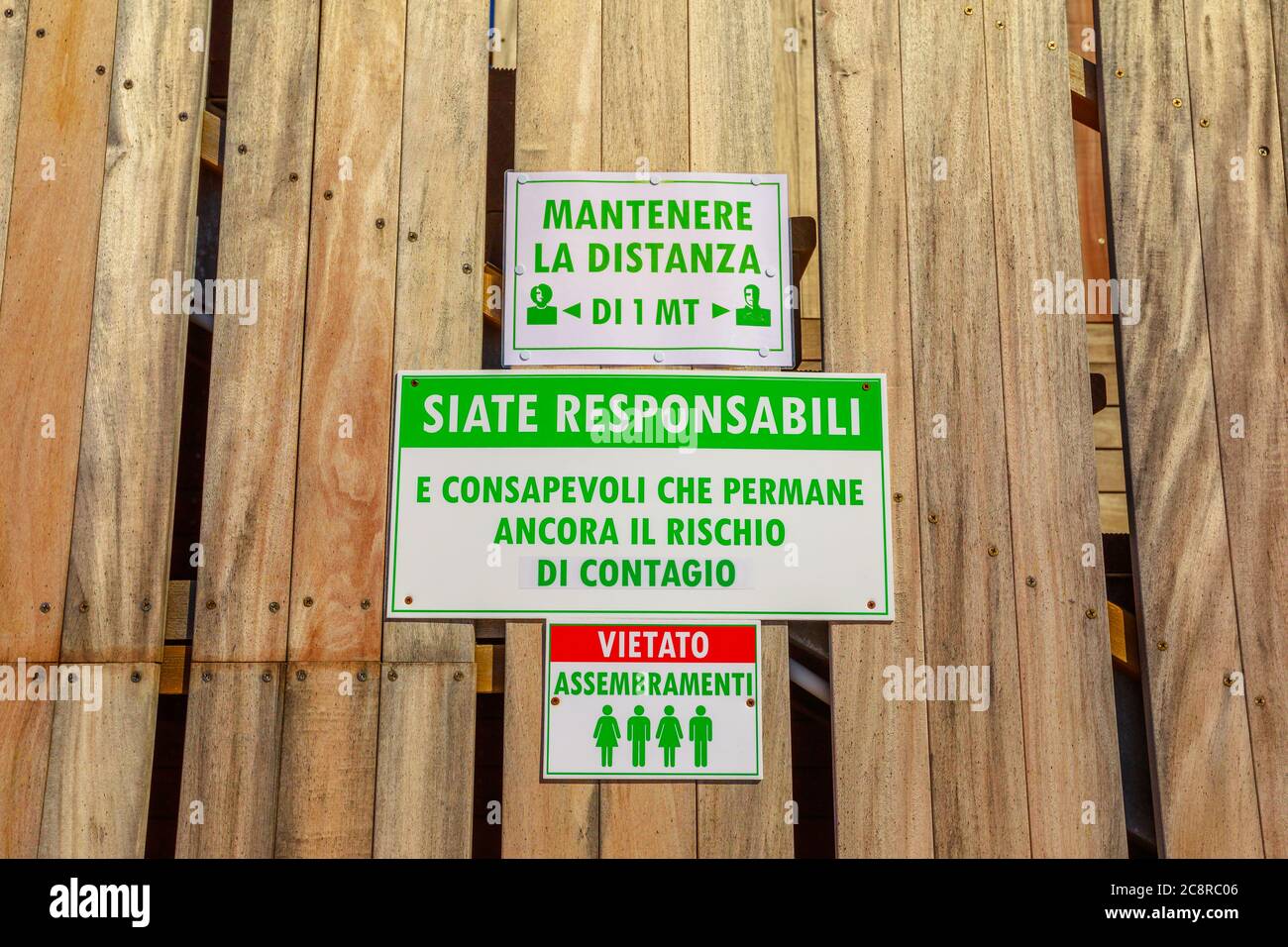Sansone Beach, Elba island, Italy - June 17, 2020: alert security sign with social distancing rules in a pub of Sansone Beach in Elba Island. summer Stock Photo