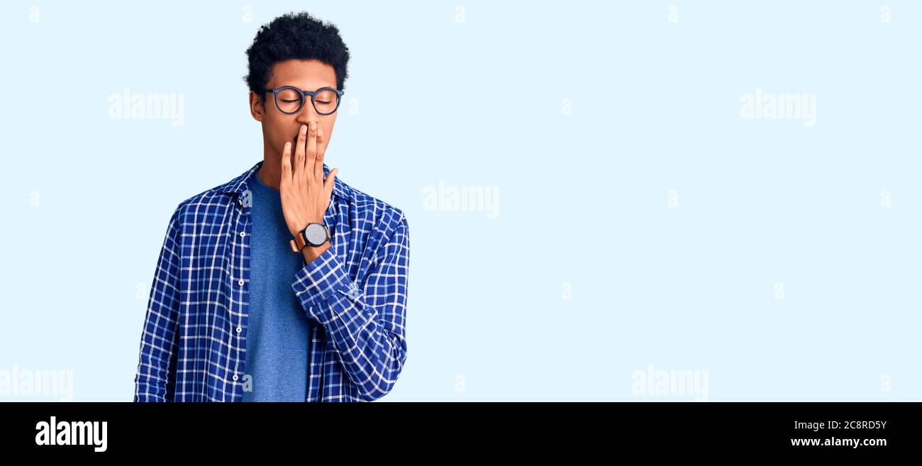 Young african american man wearing casual clothes and glasses bored ...