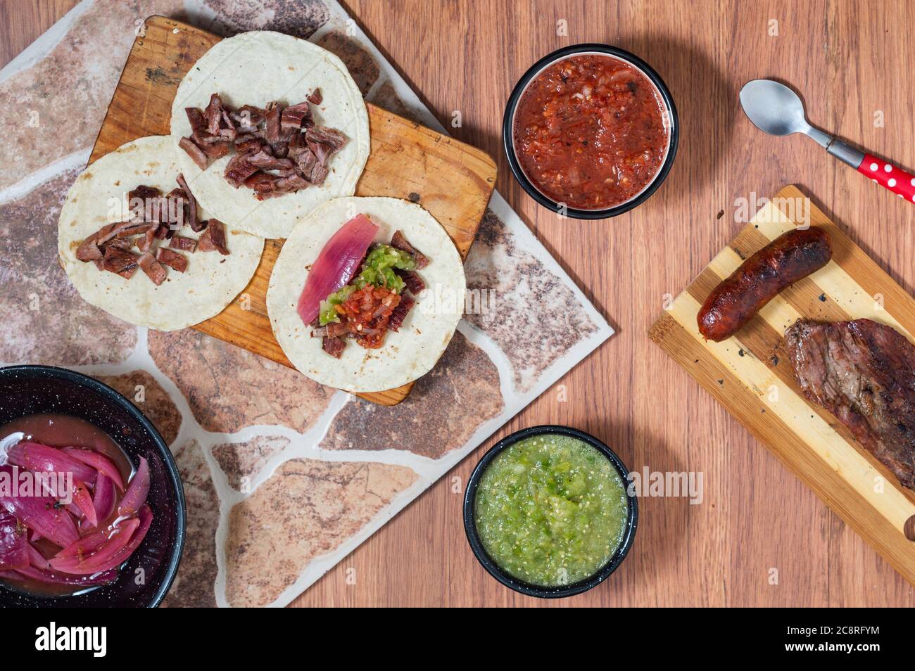 Carne Asada, Mexican barbecue, tacos of beef with homemade salsas Stock Photo