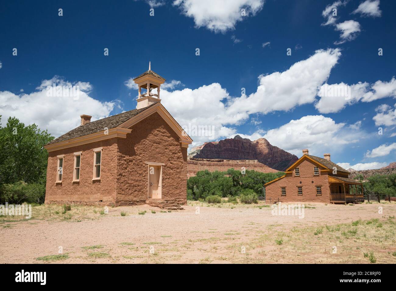 A ghost town school building and large house restored to original condition in a ghost town in Southern Utah. Stock Photo