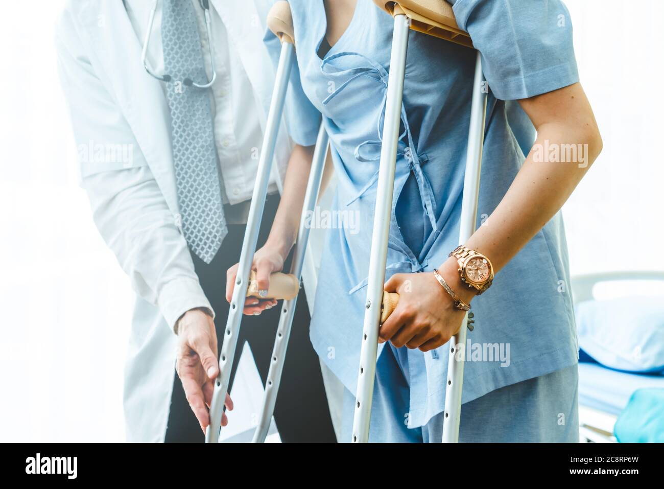Doctor takes care of patient in crutch at hospital Stock Photo Alamy