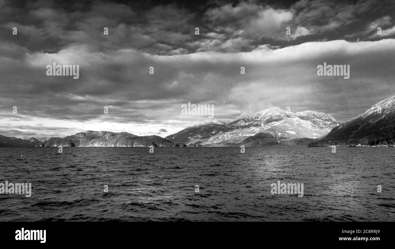 Black and White Photo of the Winter Landscape of Harrison Lake and the surrounding Mountains at Harrison Hot Springs in British Columbia, Canada Stock Photo